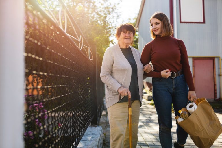 TheREDWords.website/BLOG page. A photo of a young woman assisting an elderly woman.