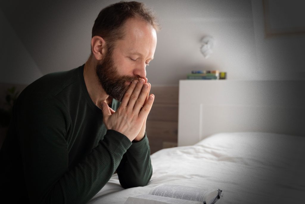 TheREDWords.website/BLOG page. A photo of man kneeling beside his bed and praying.