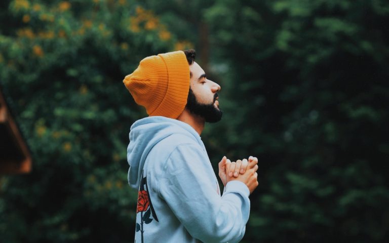 TheREDWords.website/BLOG page. A photo of a man standing in the woods and praying.