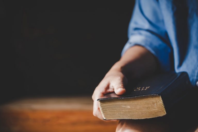 TheREDWords.website/BLOG page. A photo of a man holding the Holy Bible.