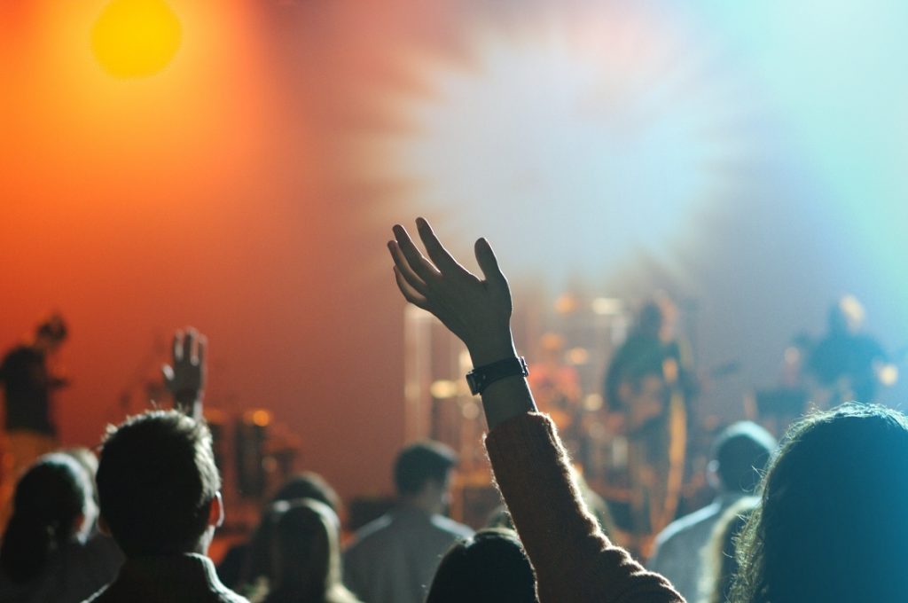 TheREDWords.website/BLOG page. A photo of a large crowd of people worshiping in a church.