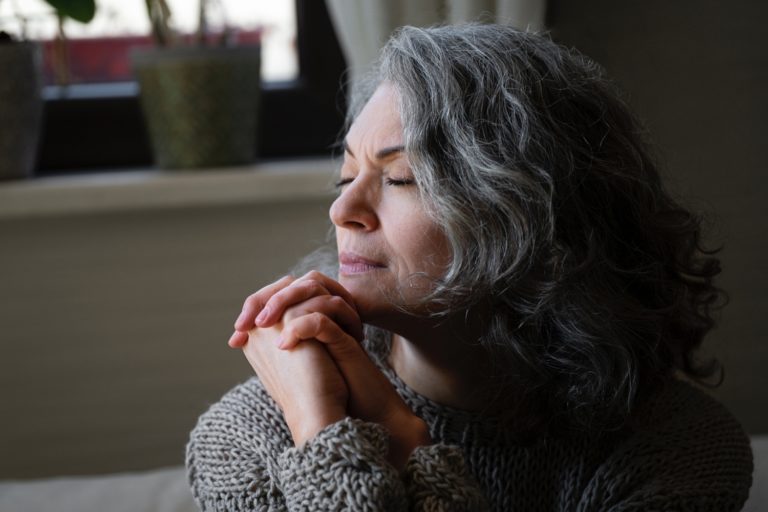 TheREDWords.website/Prayer Starter. A photo of a mature woman praying.